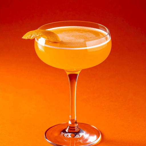 Orange Grand Marnier cocktail in coupe glass with peel garnish